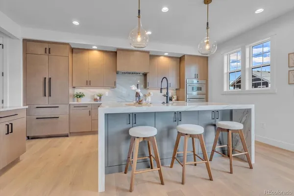 a kitchen with stainless steel appliances kitchen island granite countertop a sink and cabinets