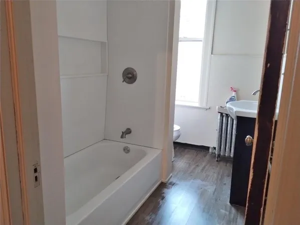 a bathroom with a bathtub and a window