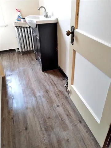 a view of a hardwood floor and staircase