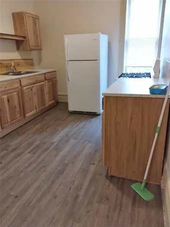 a kitchen with a refrigerator and a stove