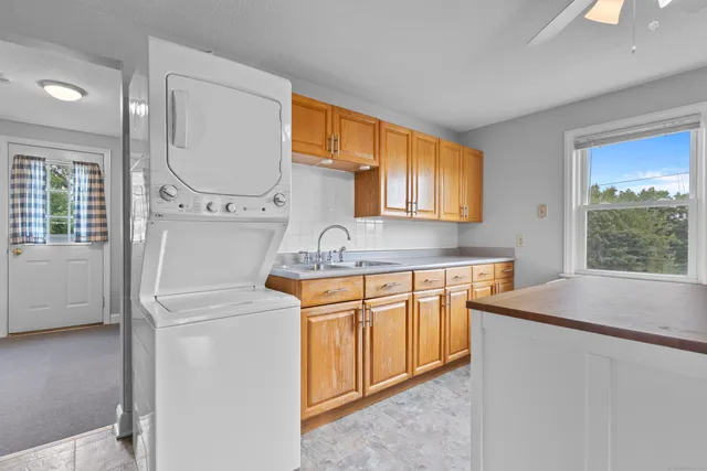 a kitchen with stainless steel appliances granite countertop a sink stove and a refrigerator