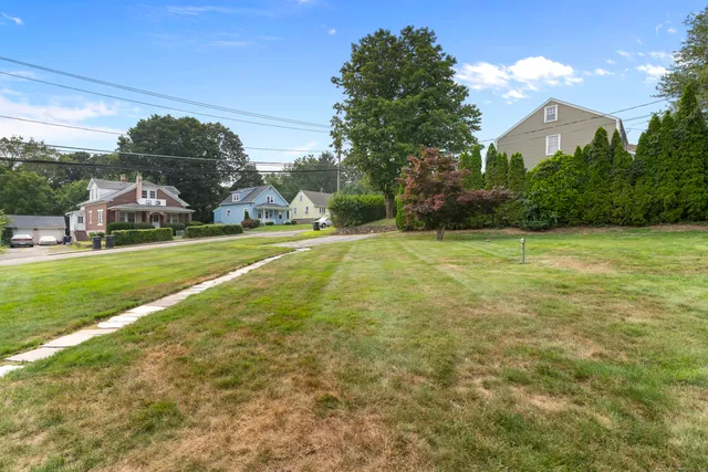 a view of a field with an trees in the background