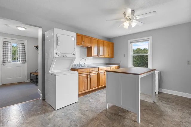 a kitchen with sink cabinets and window
