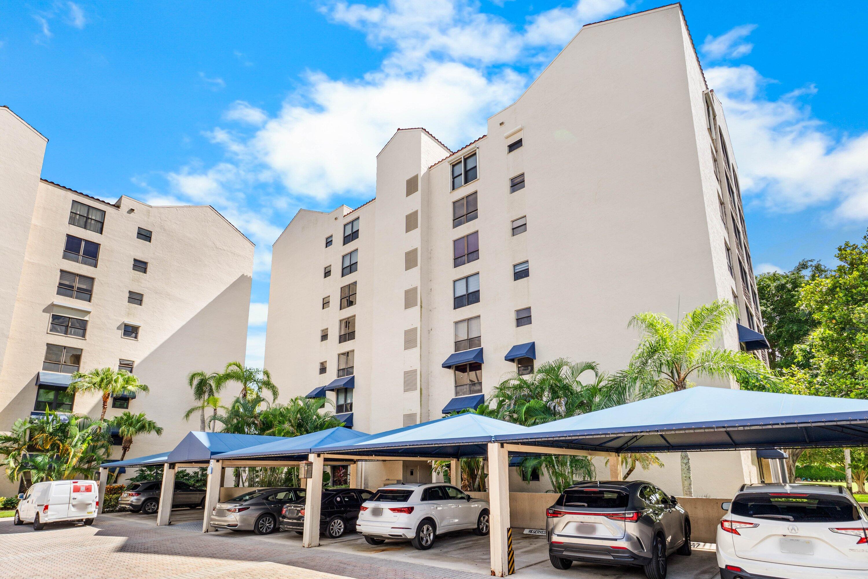 7572 Regency Lake Drive, Unit 301 Boca Raton, FL 33433 - Photo 1 of 38 a car parked in front of a building