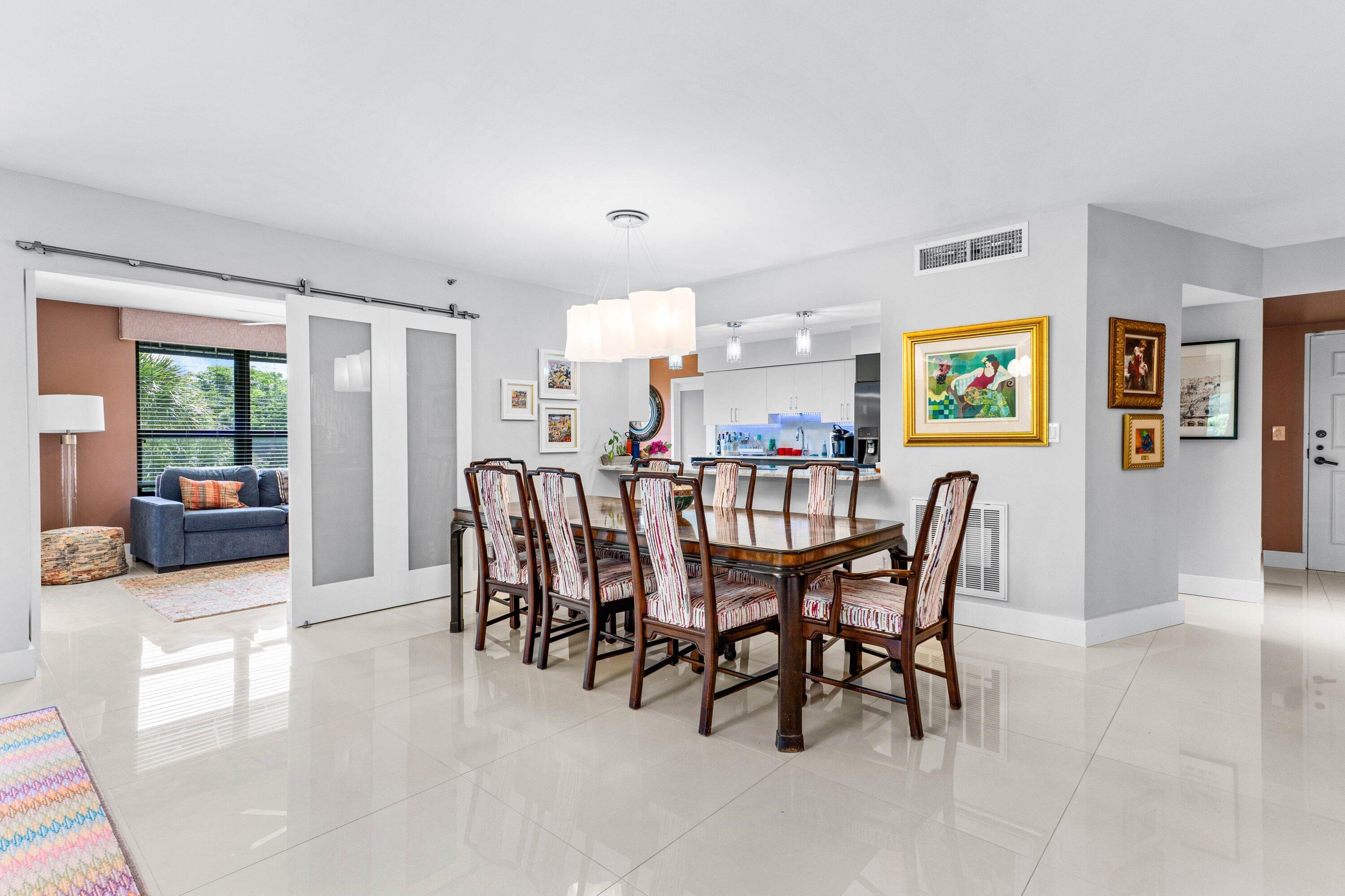 7572 Regency Lake Drive, Unit 301 Boca Raton, FL 33433 - Photo 11 of 38 a dining room with furniture and window