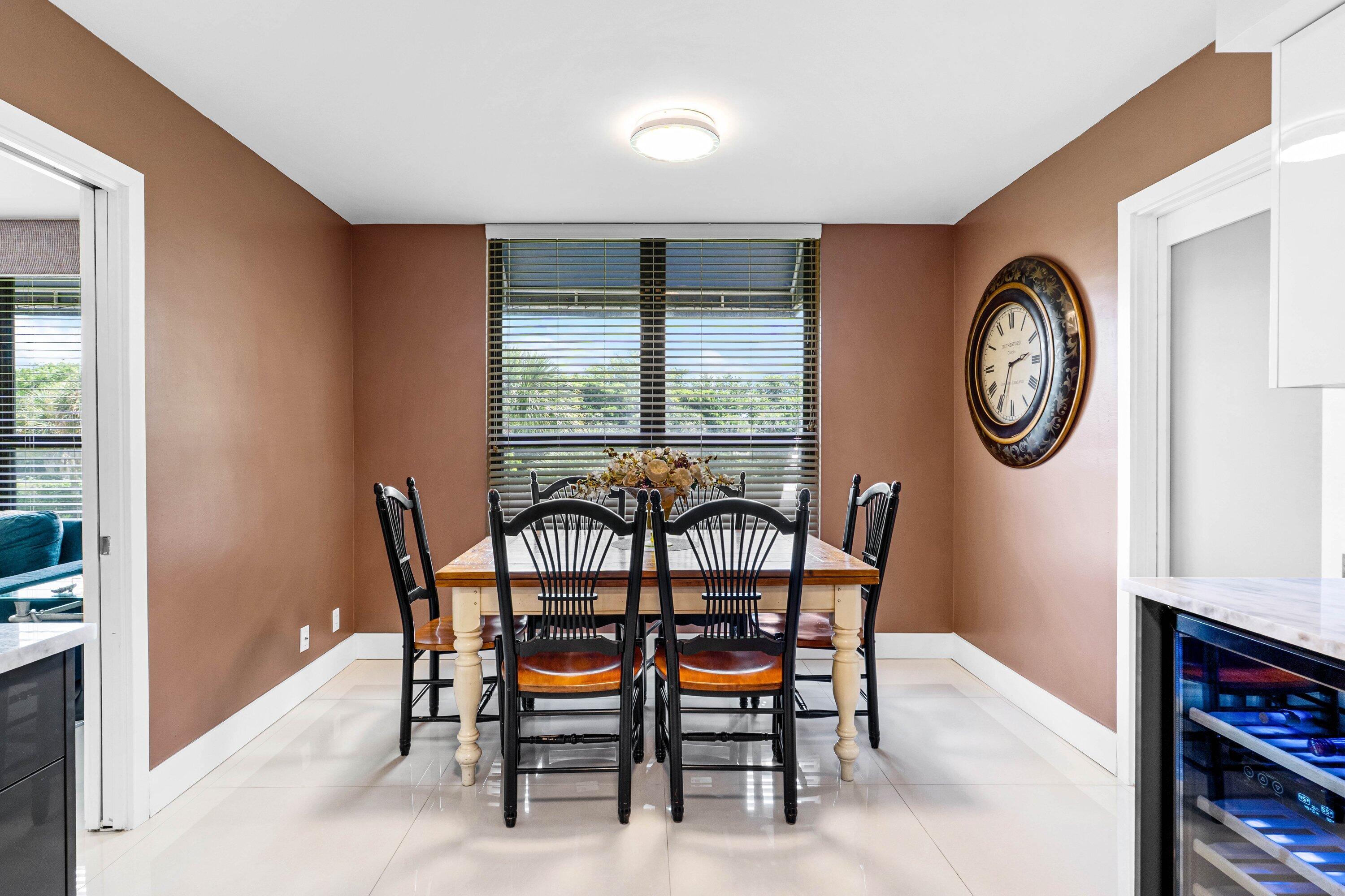 7572 Regency Lake Drive, Unit 301 Boca Raton, FL 33433 - Photo 14 of 38 a dining room with furniture and a window