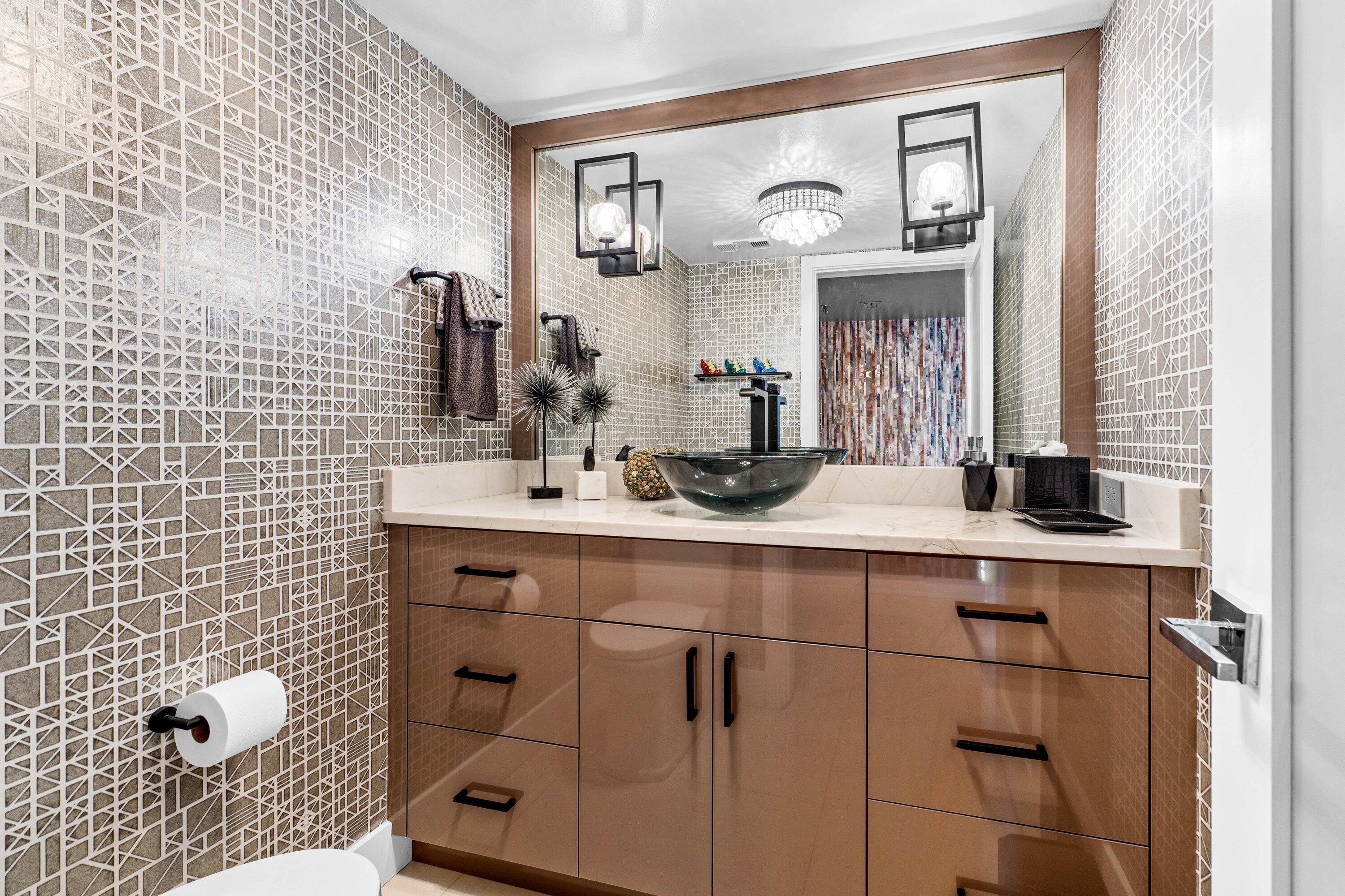 7572 Regency Lake Drive, Unit 301 Boca Raton, FL 33433 - Photo 17 of 38 a bathroom with a sink vanity and mirror