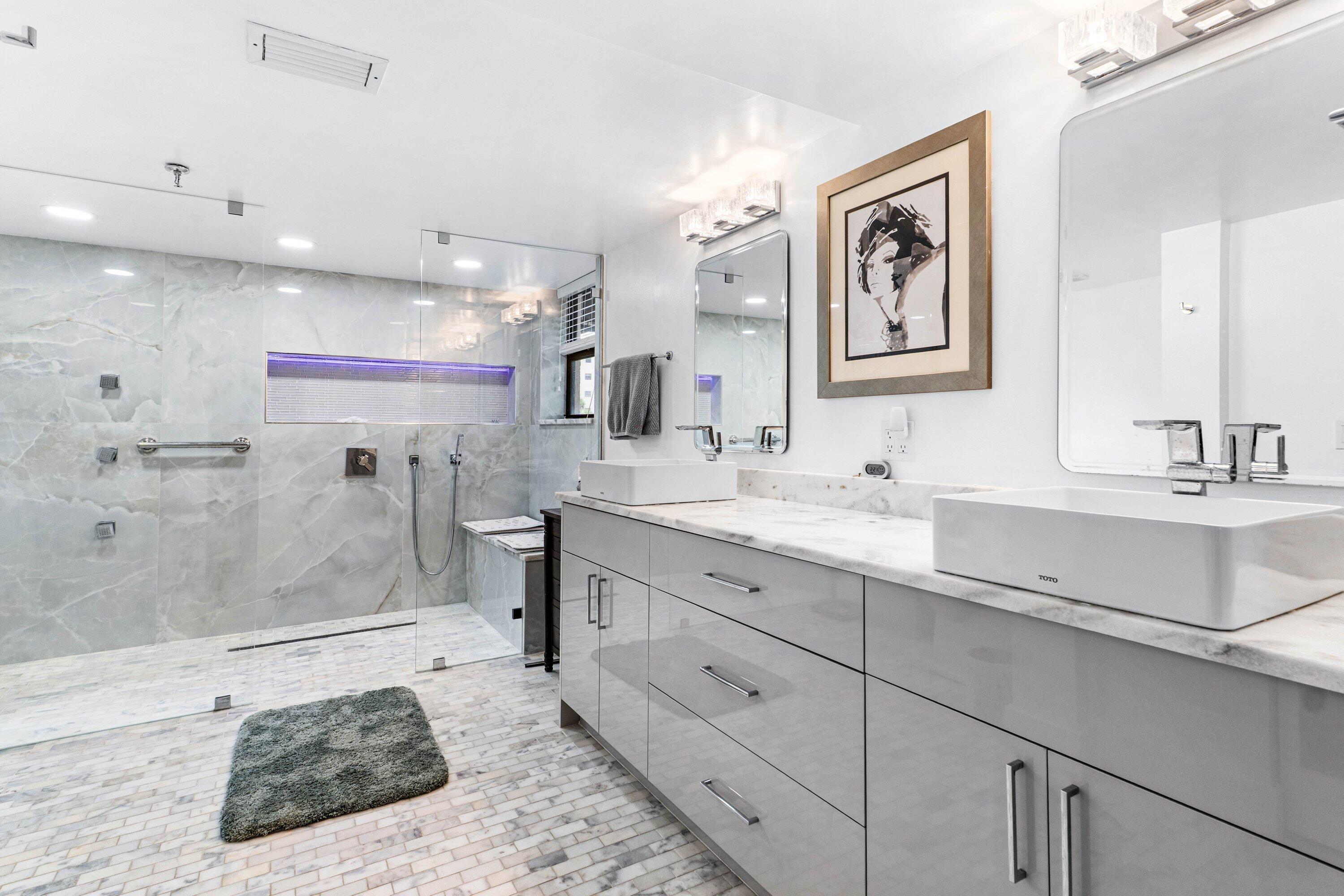 7572 Regency Lake Drive, Unit 301 Boca Raton, FL 33433 - Photo 22 of 38 a bathroom with a sink a double vanity and a shower