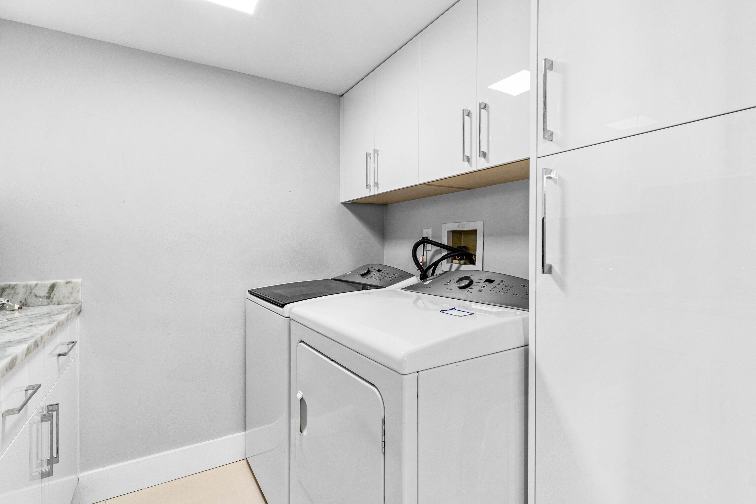 7572 Regency Lake Drive, Unit 301 Boca Raton, FL 33433 - Photo 24 of 38 a utility room with dryer and washer