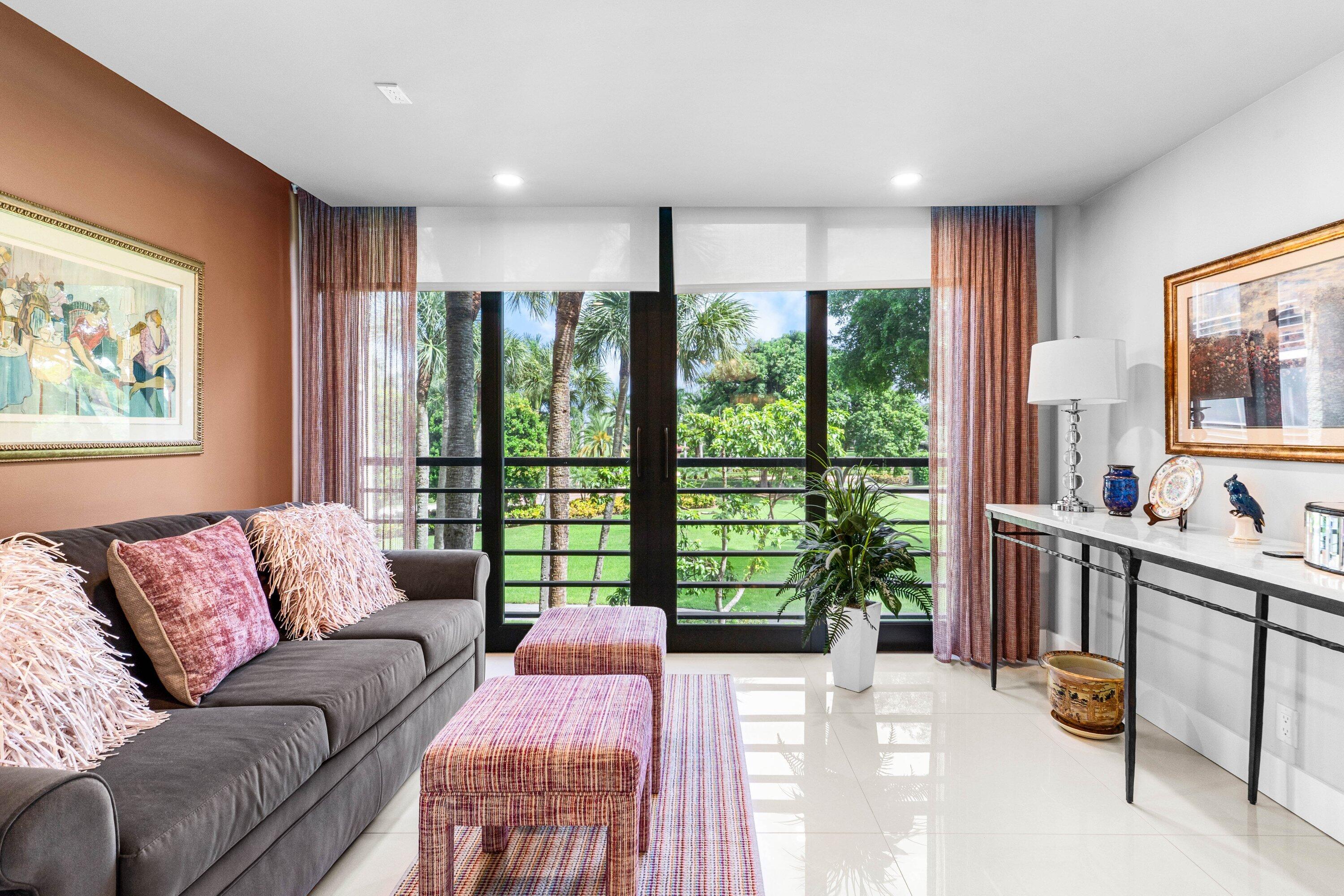 7572 Regency Lake Drive, Unit 301 Boca Raton, FL 33433 - Photo 26 of 38 a living room with furniture and a flat screen tv