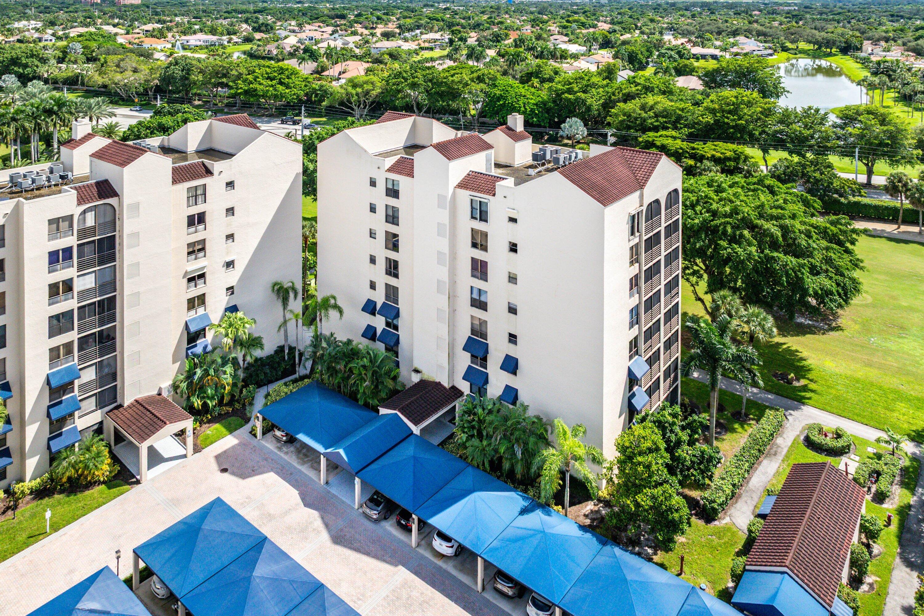 7572 Regency Lake Drive, Unit 301 Boca Raton, FL 33433 - Photo 30 of 38 an aerial view of building with yard and parking spaces