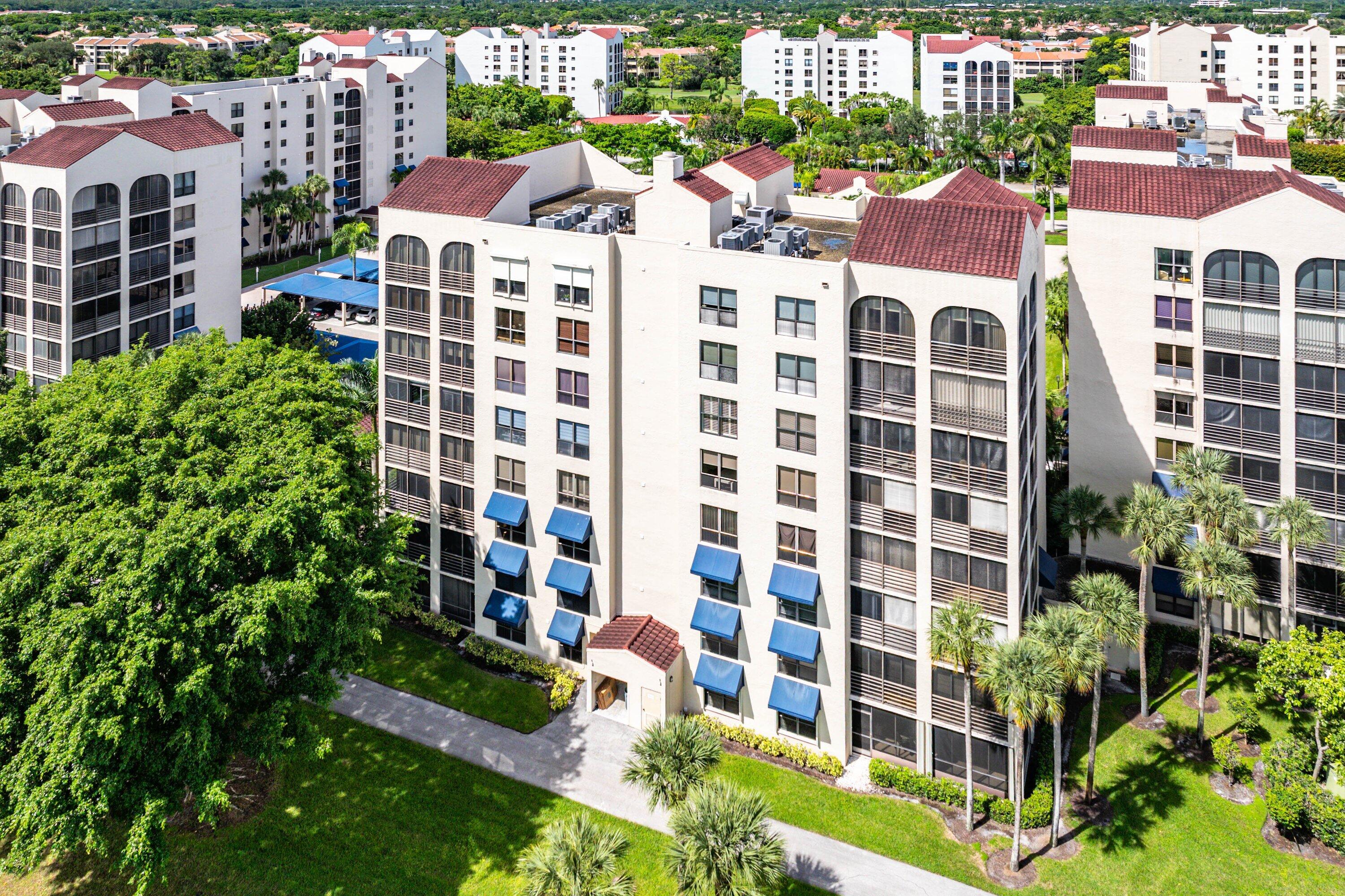 7572 Regency Lake Drive, Unit 301 Boca Raton, FL 33433 - Photo 32 of 38 a view of a city with tall buildings