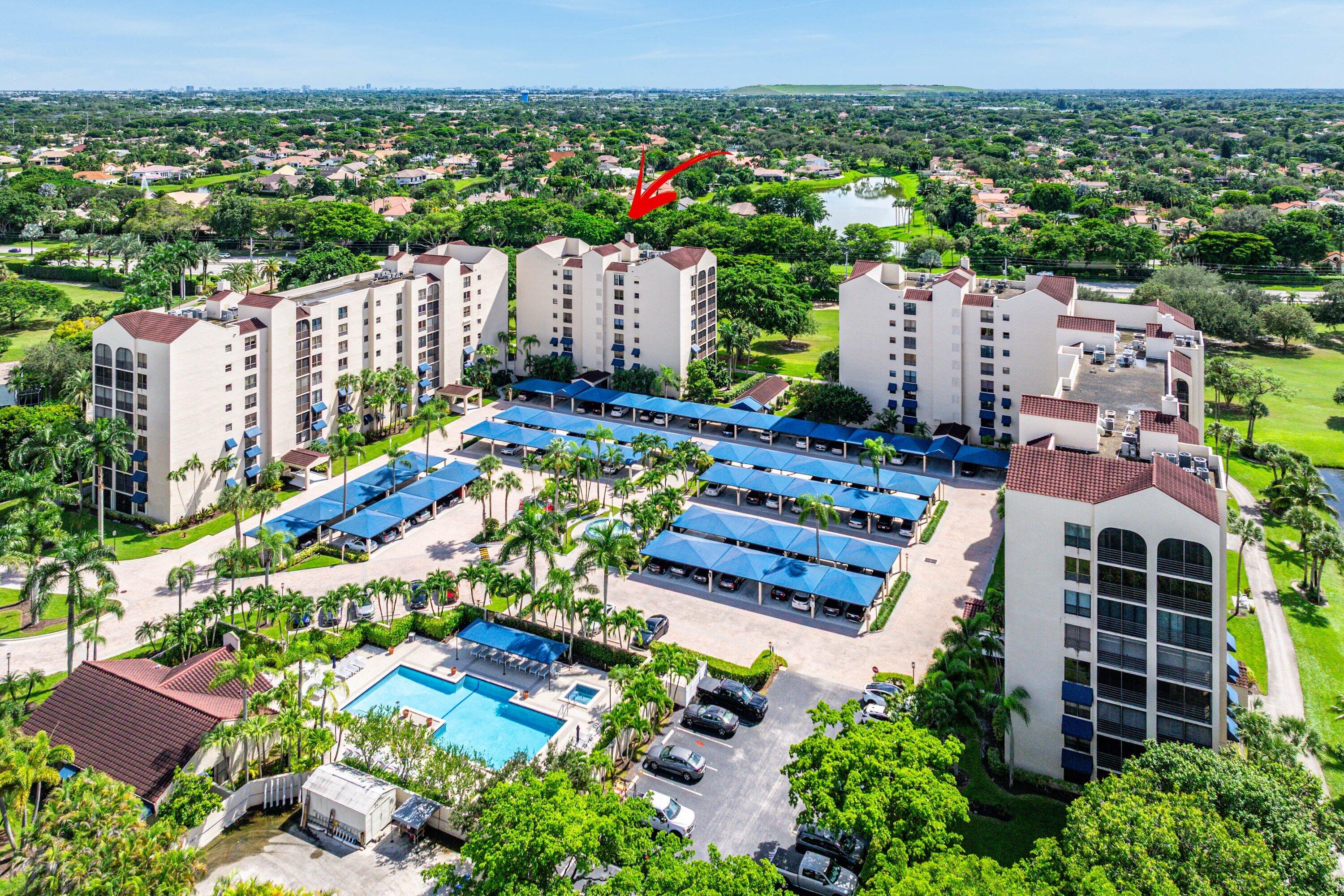 7572 Regency Lake Drive, Unit 301 Boca Raton, FL 33433 - Photo 33 of 38 an aerial view of a city with lots of residential buildings ocean and mountain view in back