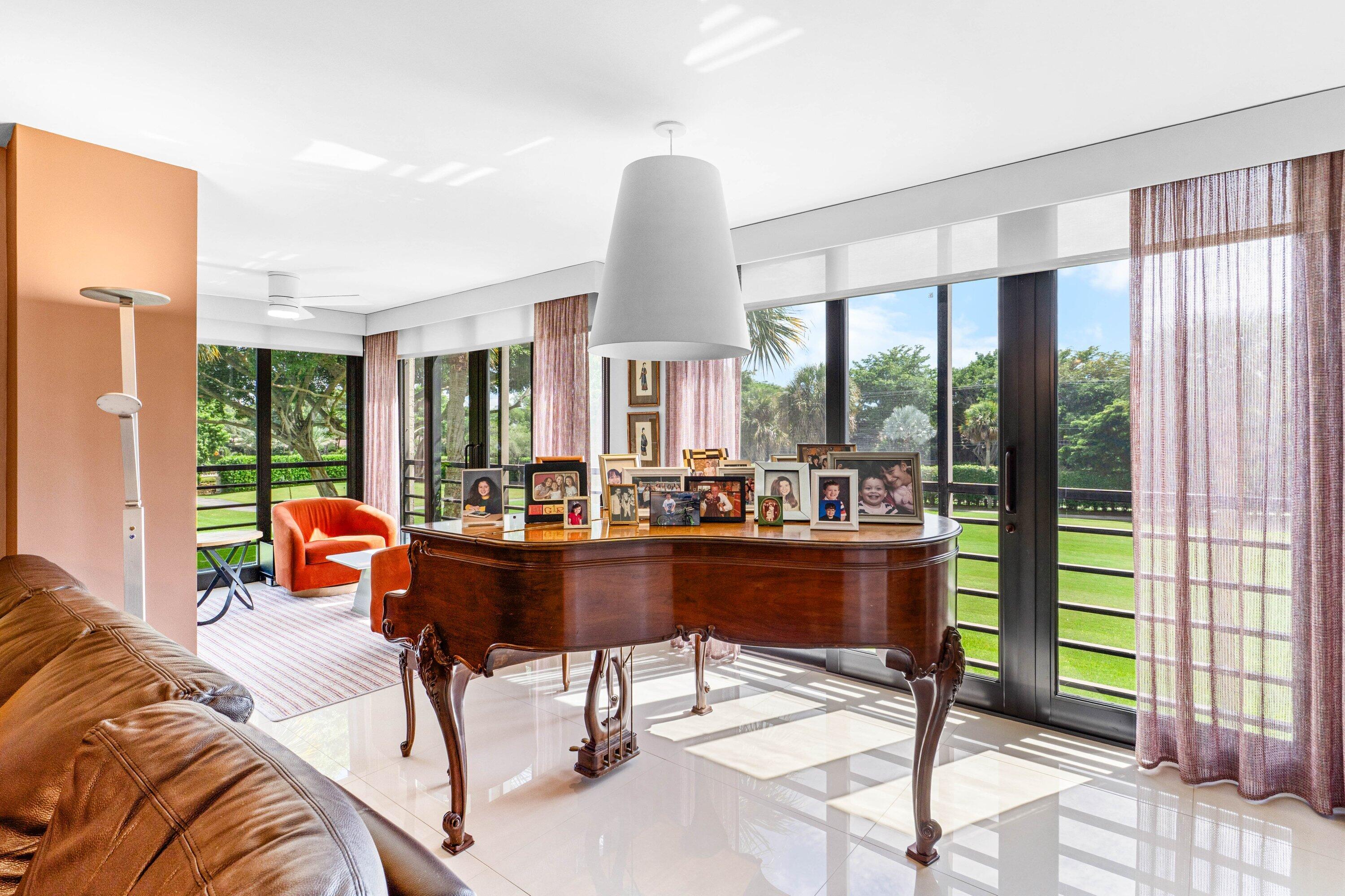 7572 Regency Lake Drive, Unit 301 Boca Raton, FL 33433 - Photo 6 of 38 a living room with furniture and a large window