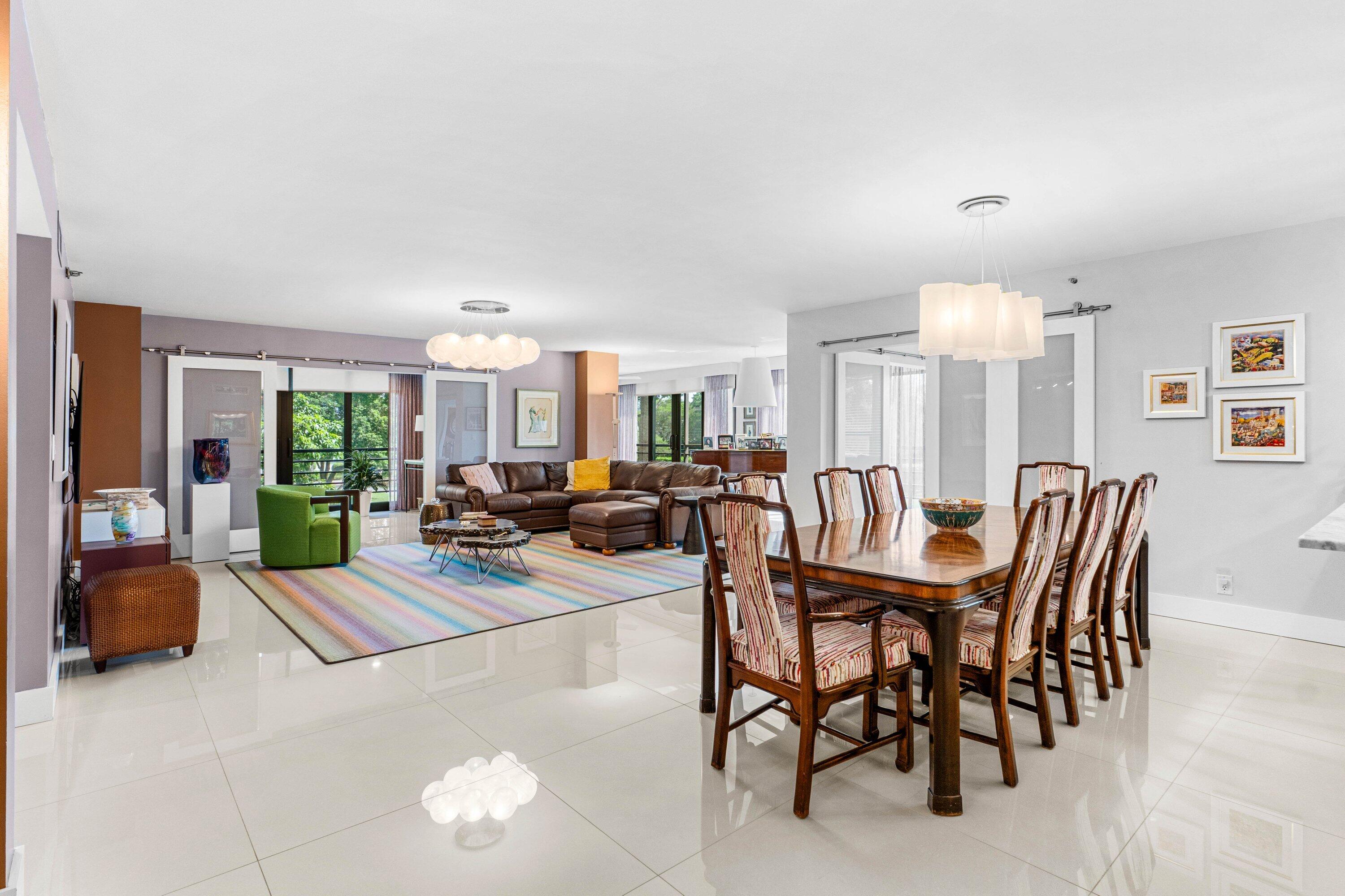 7572 Regency Lake Drive, Unit 301 Boca Raton, FL 33433 - Photo 7 of 38 a living room with furniture kitchen view and a large window