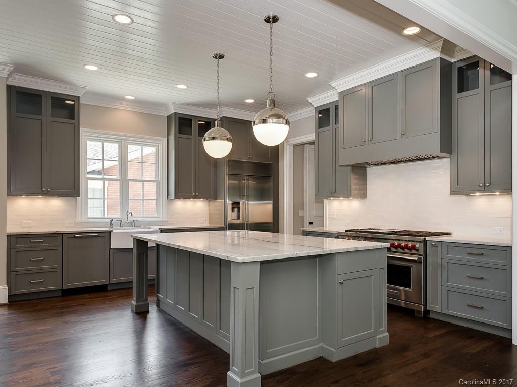 a kitchen with stainless steel appliances granite countertop wooden floors and sink