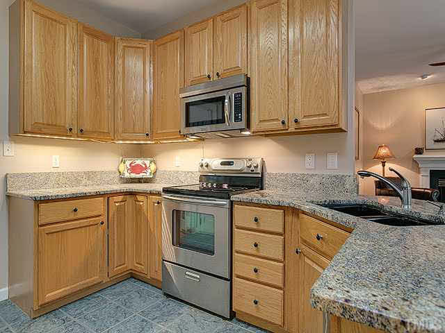 805 Bromley Way Raleigh, NC 27615 - Photo 7 of 25 Open kitchen with large bar that opens to living/family room. Fits 4 barstools. Kitchen