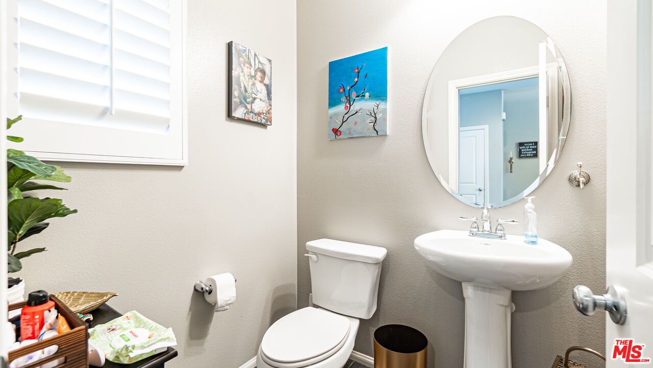 3564 Albion Drive Oxnard, CA 93036 - Photo 17 of 41 a bathroom with a toilet sink and mirror