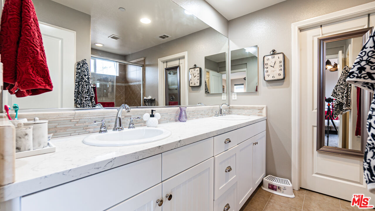 3564 Albion Drive Oxnard, CA 93036 - Photo 27 of 41 a bathroom with a double vanity sink and a mirror