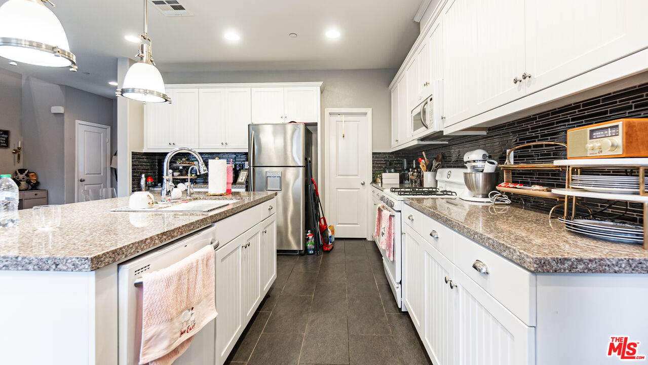 3564 Albion Drive Oxnard, CA 93036 - Photo 8 of 41 a kitchen with stainless steel appliances granite countertop a sink a stove and a refrigerator