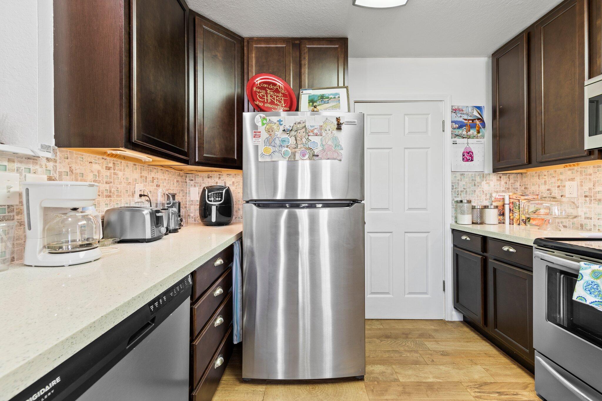 6066 Old Bethel Road Crestview, FL 32536 - Photo 12 of 25 a kitchen with stainless steel appliances granite countertop a refrigerator and a sink