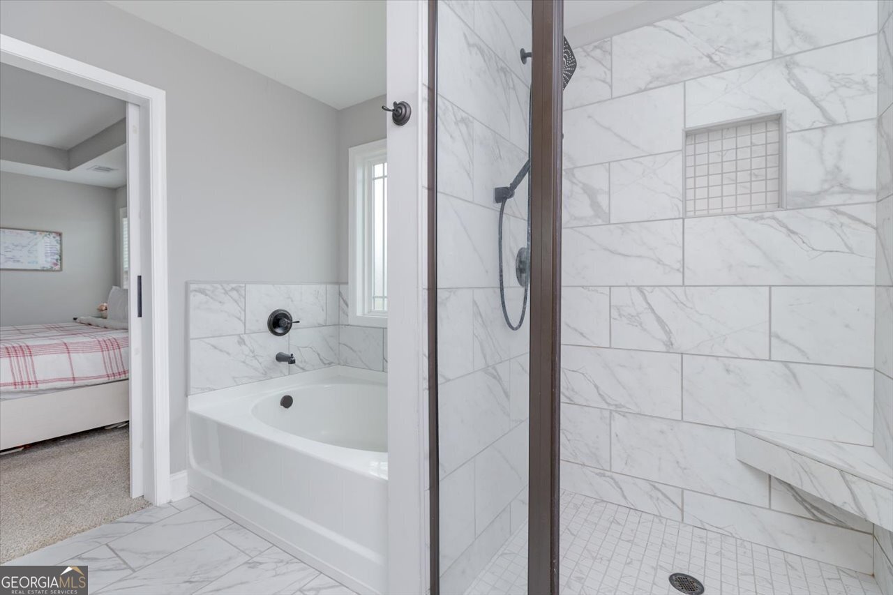 104 Meredith Layne Court Perry, GA 31069 - Photo 28 of 46 a bathroom with a bathtub and a shower