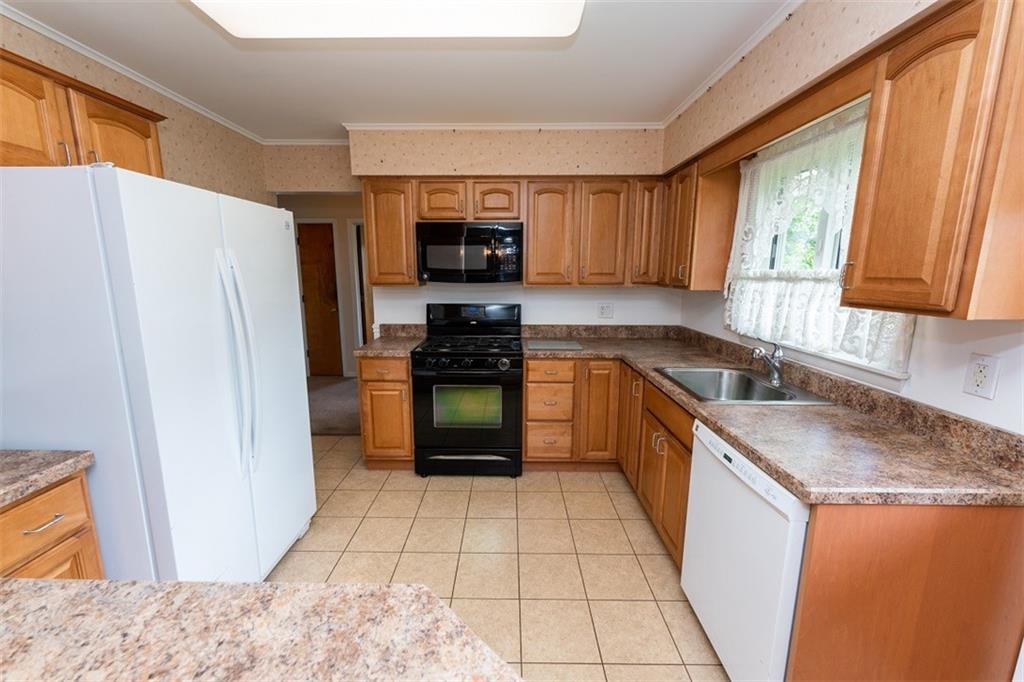 155 Meadow Wood Road Indiana, PA 15701 - Photo 7 of 15 a kitchen with stainless steel appliances granite countertop a refrigerator sink and stove