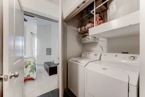 a view of storage and utility room with washer and dryer
