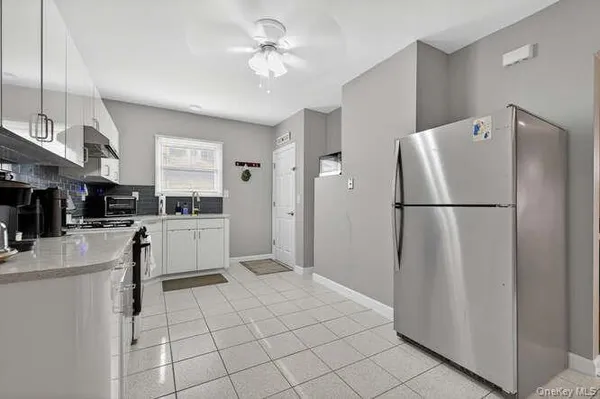 a kitchen with white cabinets and white appliances