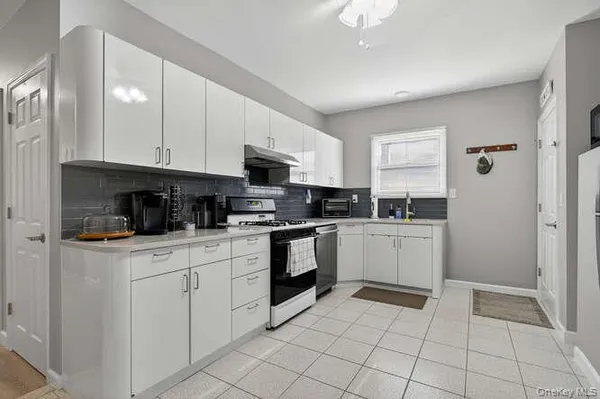 a kitchen with a sink a stove and cabinets