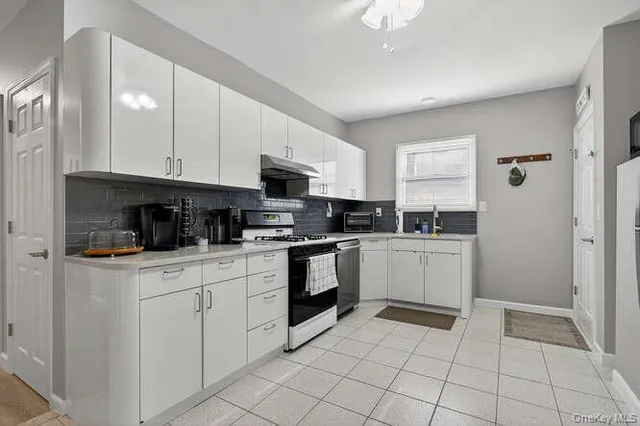 a kitchen with a sink a stove and cabinets