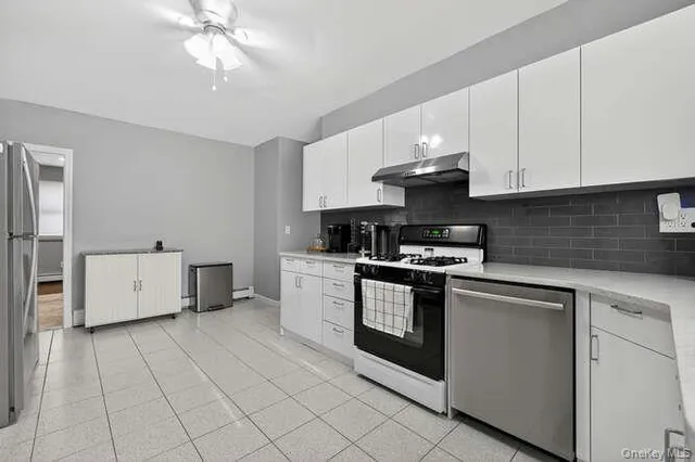 a kitchen with stainless steel appliances granite countertop a sink and cabinets