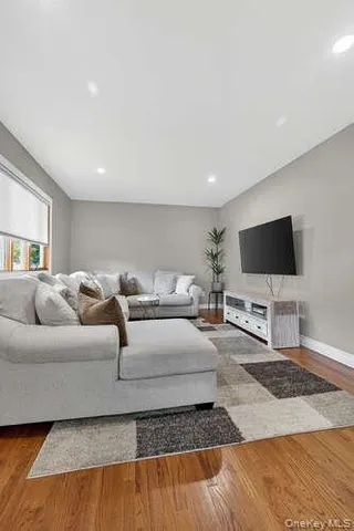 a living room with a flat screen tv and a lamp