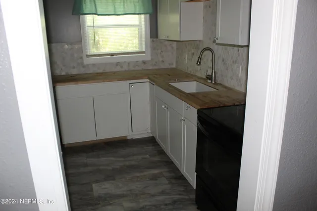 a kitchen with a sink and a window