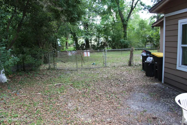 a backyard of a house with table and chairs