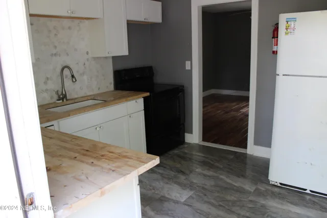 a kitchen with a refrigerator and a sink