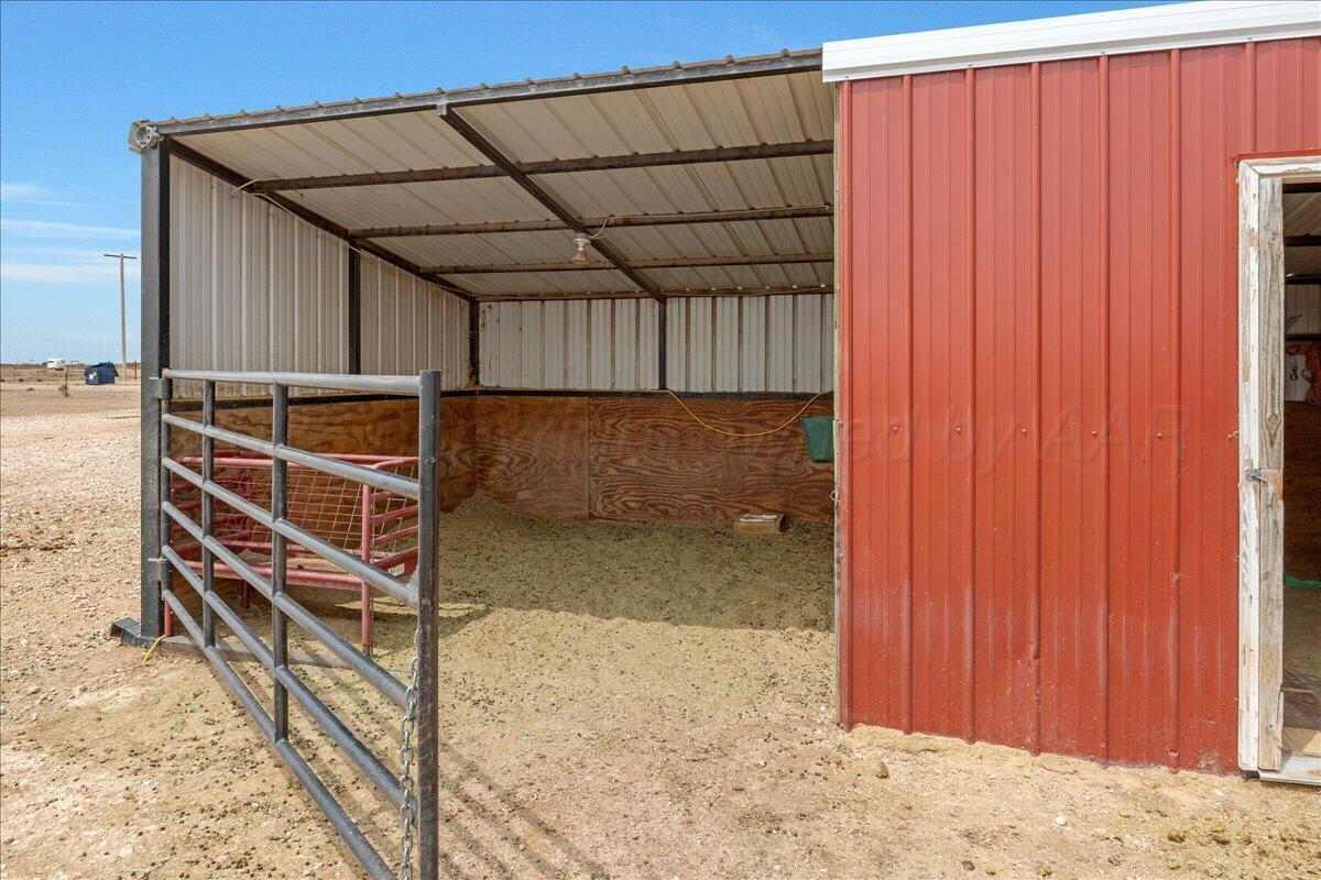 10551 Anderson Road Amarillo, TX 79118 - Photo 10 of 28 a view of an empty room with wooden walls