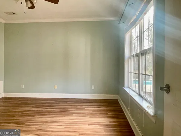 a view of a room with window and wooden floor
