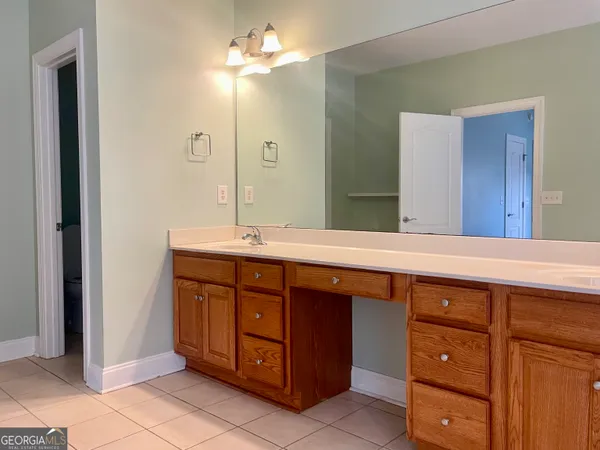 a bathroom with a double vanity sink and a mirror