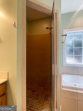 a bathroom with a shower and a sink