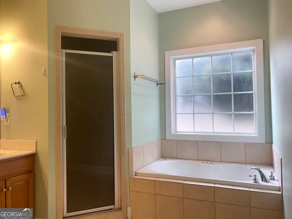 a bathroom with a bathtub and a window