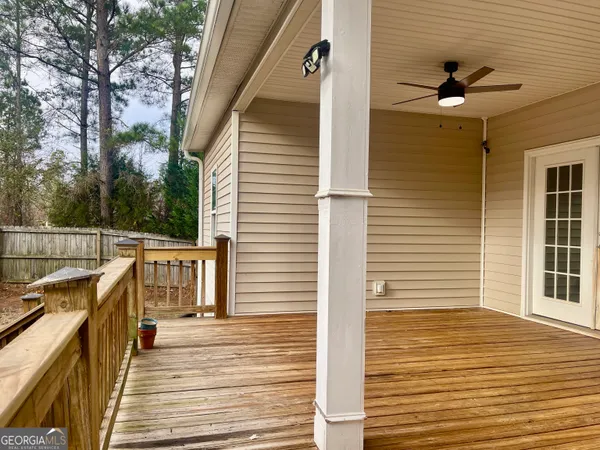a house view with a sitting space and trees