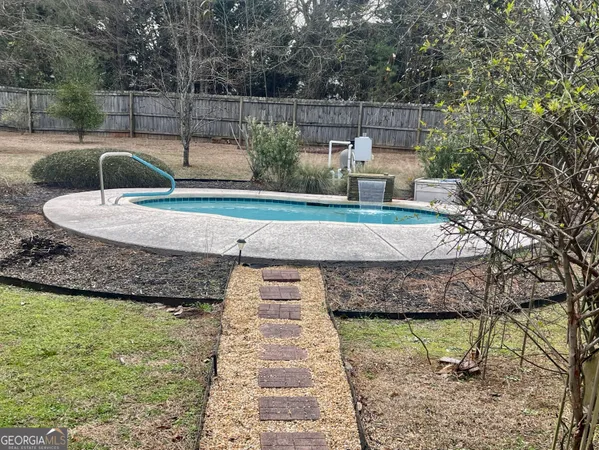a view of a swimming pool with a yard