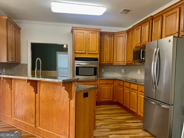 a kitchen with stainless steel appliances granite countertop a refrigerator a sink and dishwasher
