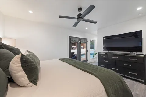 a bedroom with a bed and a flat screen tv