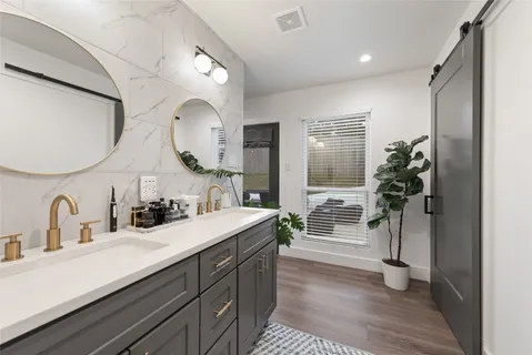 a bathroom with a double vanity sink and a mirror
