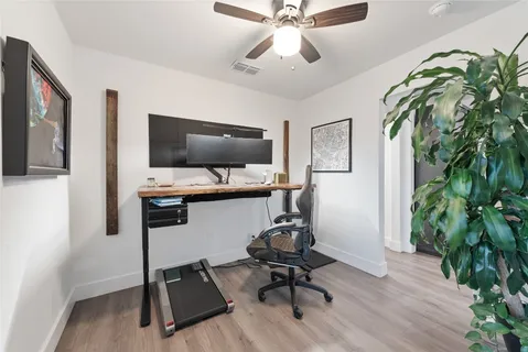 a view of a workspace with furniture and a flat screen tv