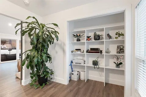 a living room with furniture and a potted plant