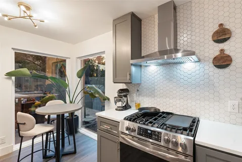 a kitchen with a stove and a refrigerator
