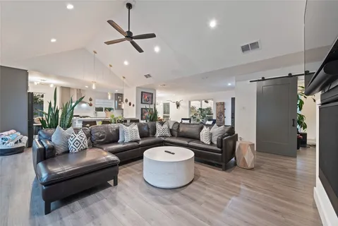 a living room with furniture and a wooden floor